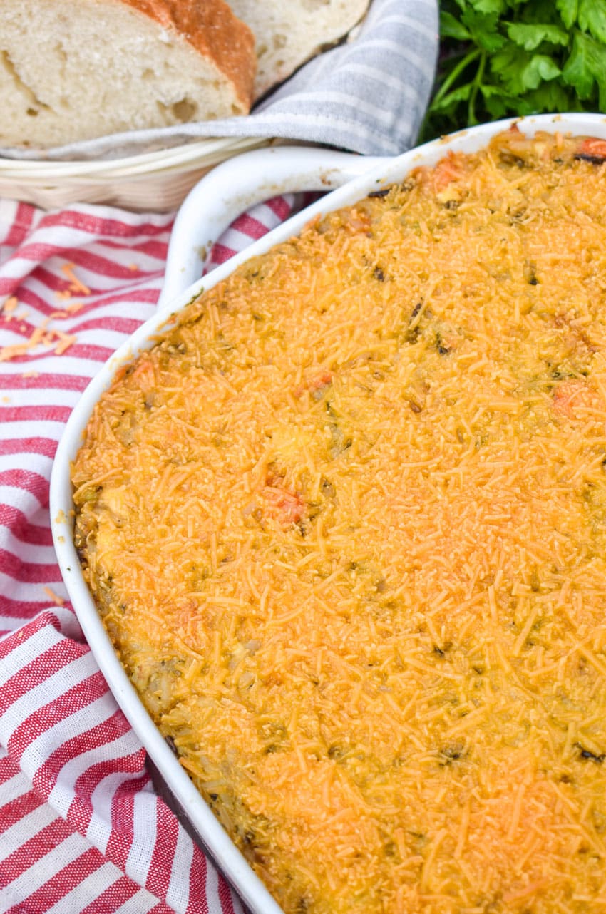 cheesy chicken wild rice casserole in a white baking dish