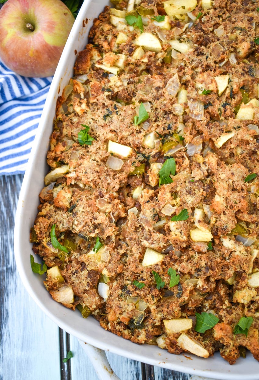 sausage, apple, and sage dressing in a white baking dish