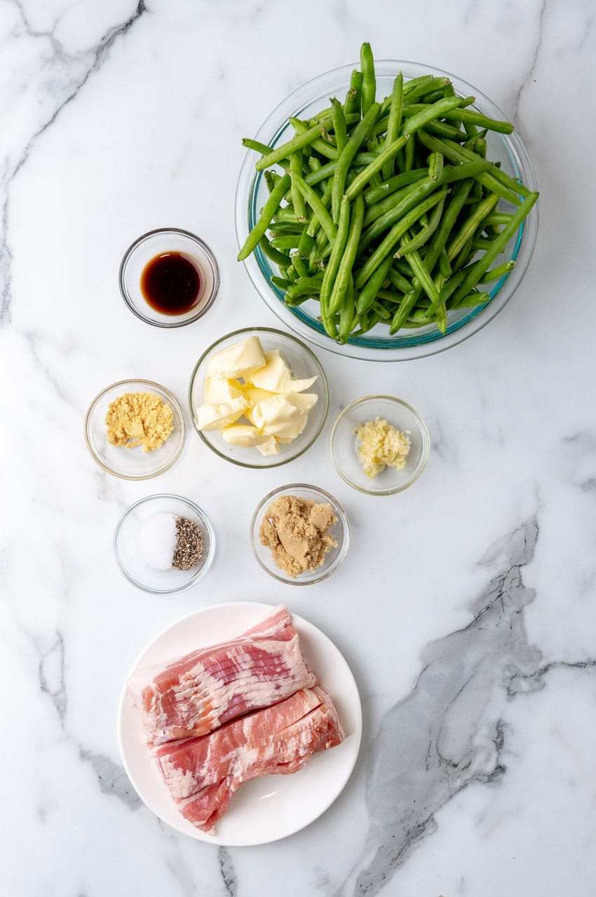 an overhead image showing the measured ingredients needed to make a batch of bacon wrapped green bean bundles