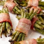 bacon wrapped green bean bundles on a white serving platter