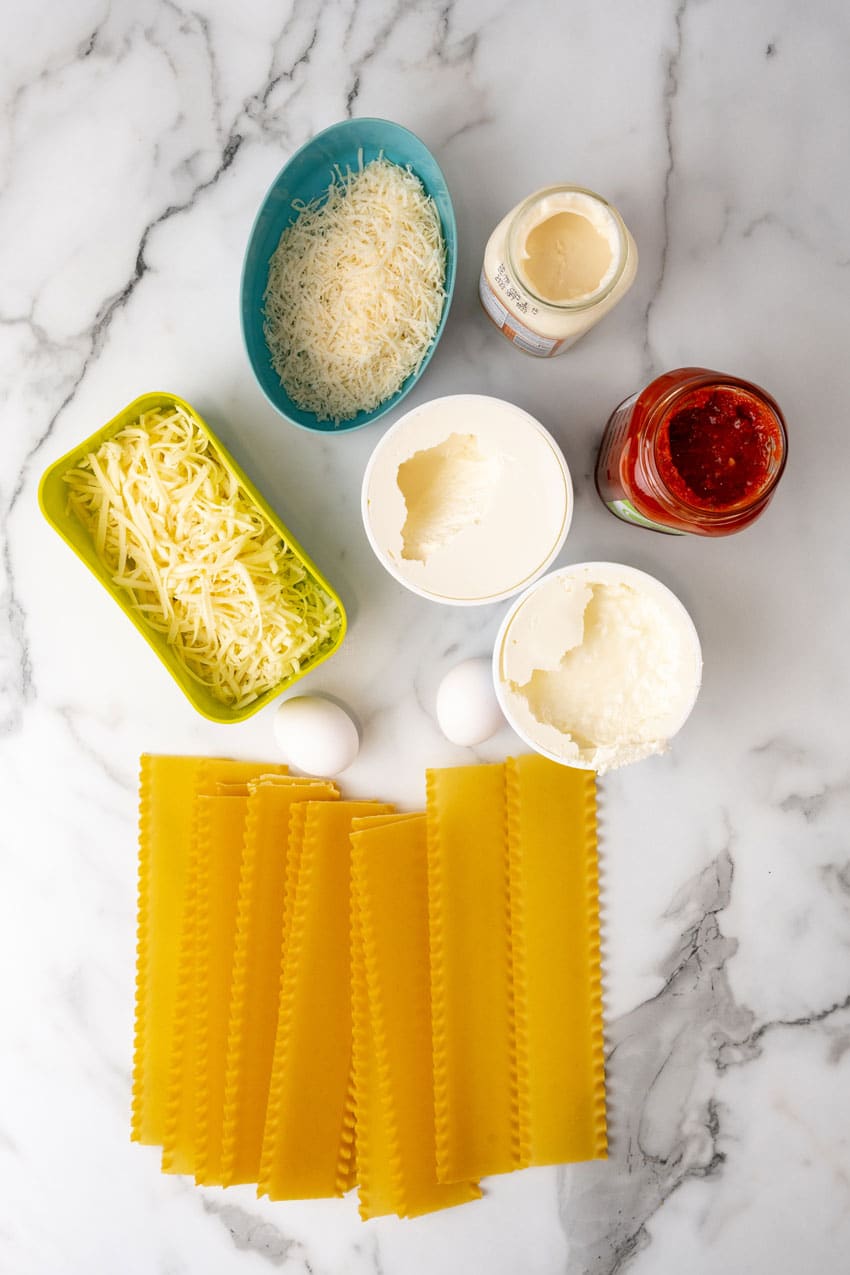 an overhead image showing the measured ingredients needed to make a lasagna with blush sauce