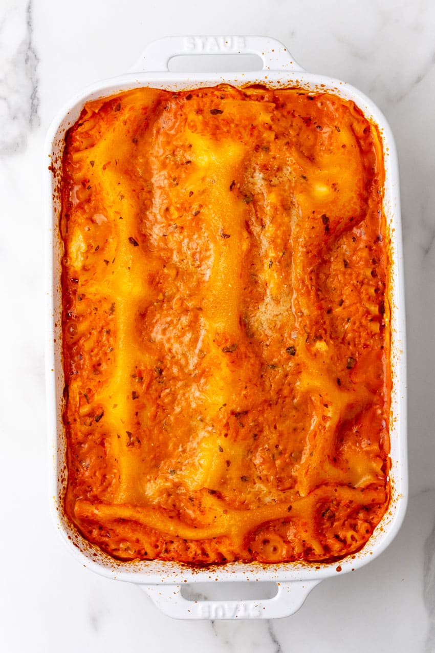 a baked lasagna rosa in a white casserole dish on a marble countertop