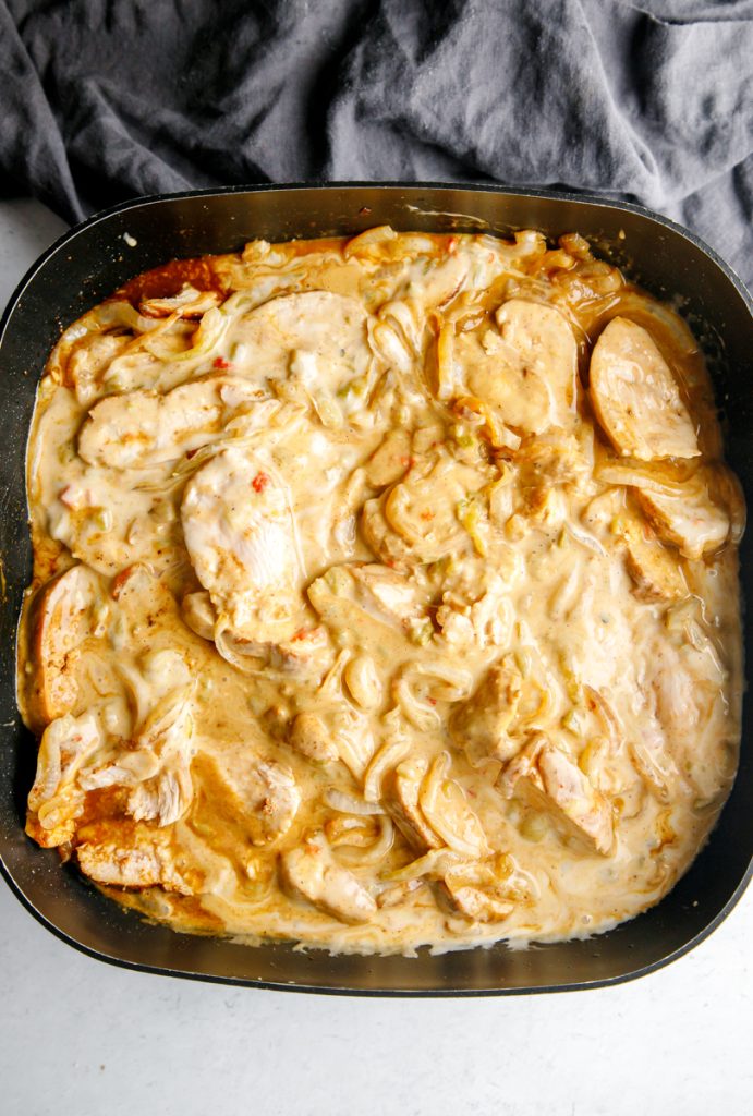 chicken queso fundido in a large black skillet