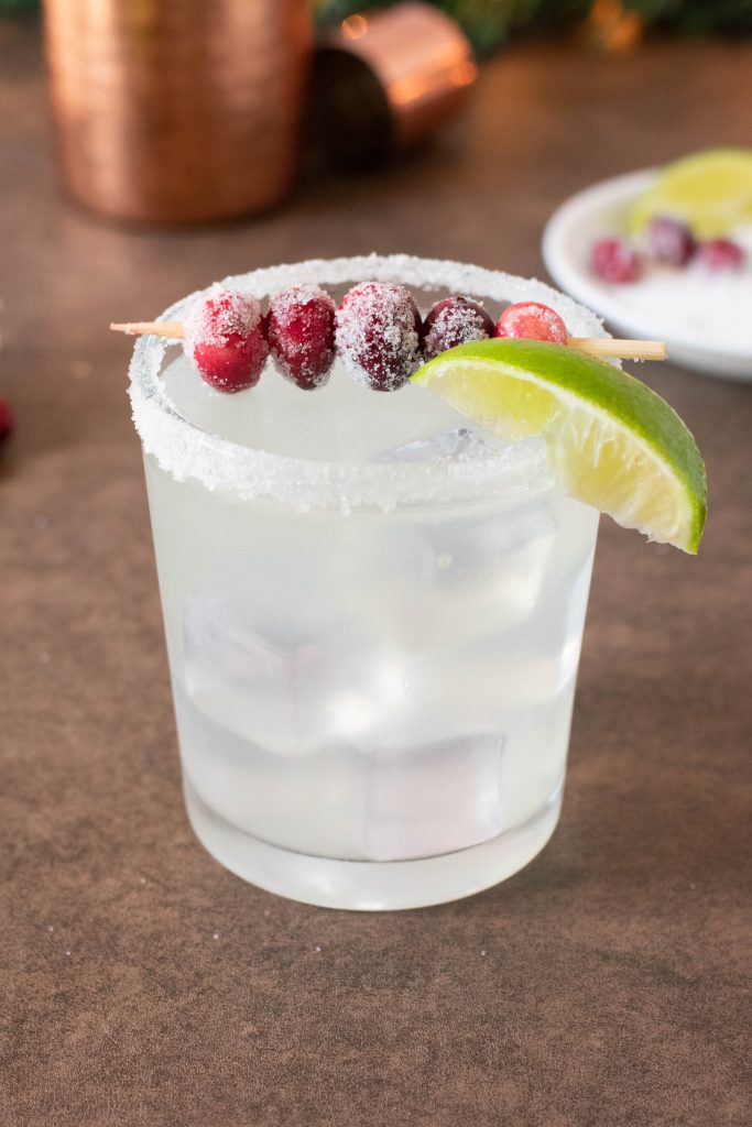 glass of margarita with cranberries on top