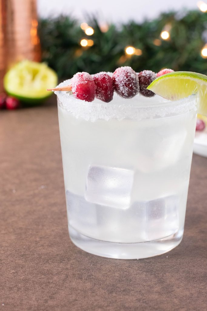 glass of margarita with cranberries on top