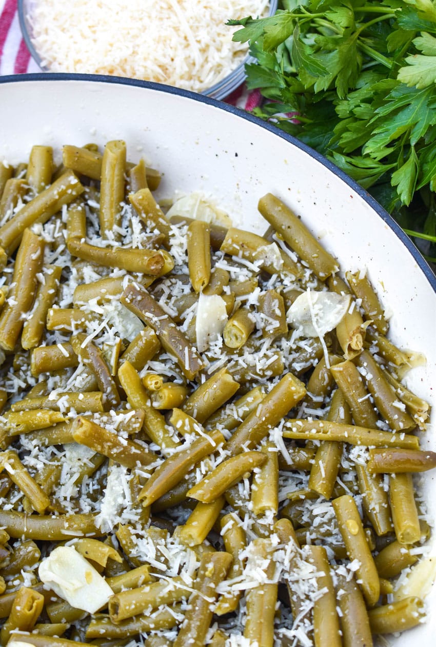garlic parmesan canned green beans in a large cast iron skillet