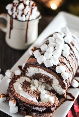 sliced hot chocolate cake roll on a white serving platter