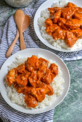 chicken tikka masala in top of steamed white rice in two white bowls