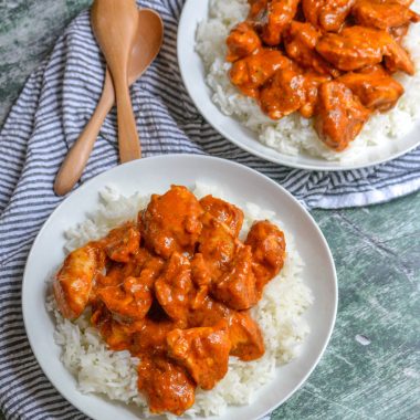 chicken tikka masala in top of steamed white rice in two white bowls