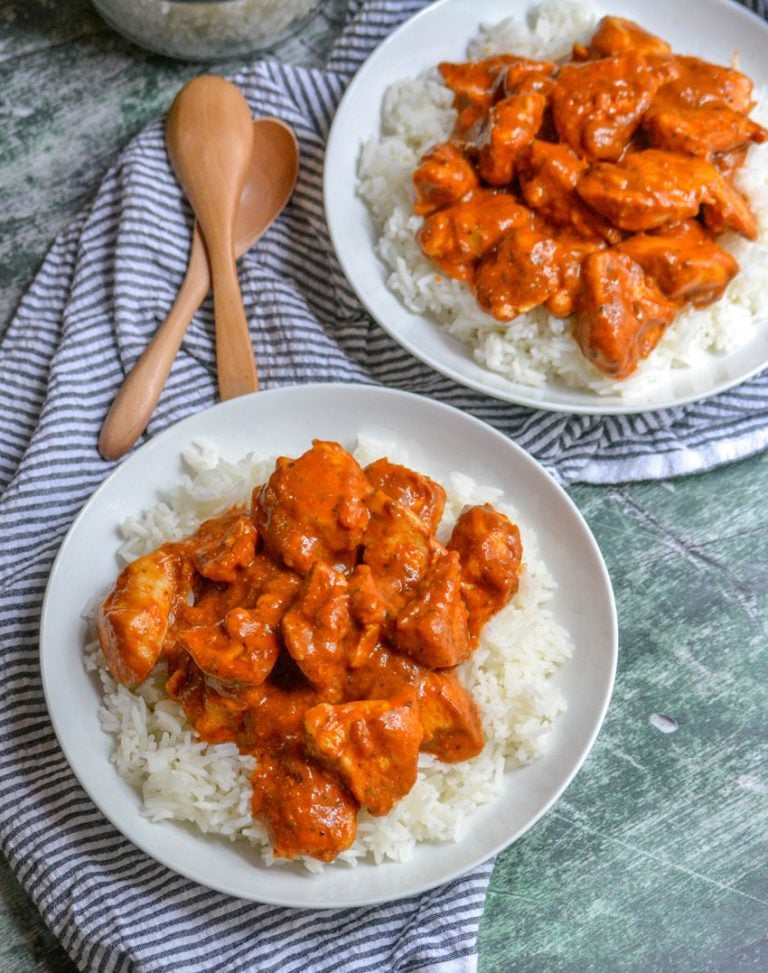 chicken tikka masala in top of steamed white rice in two white bowls