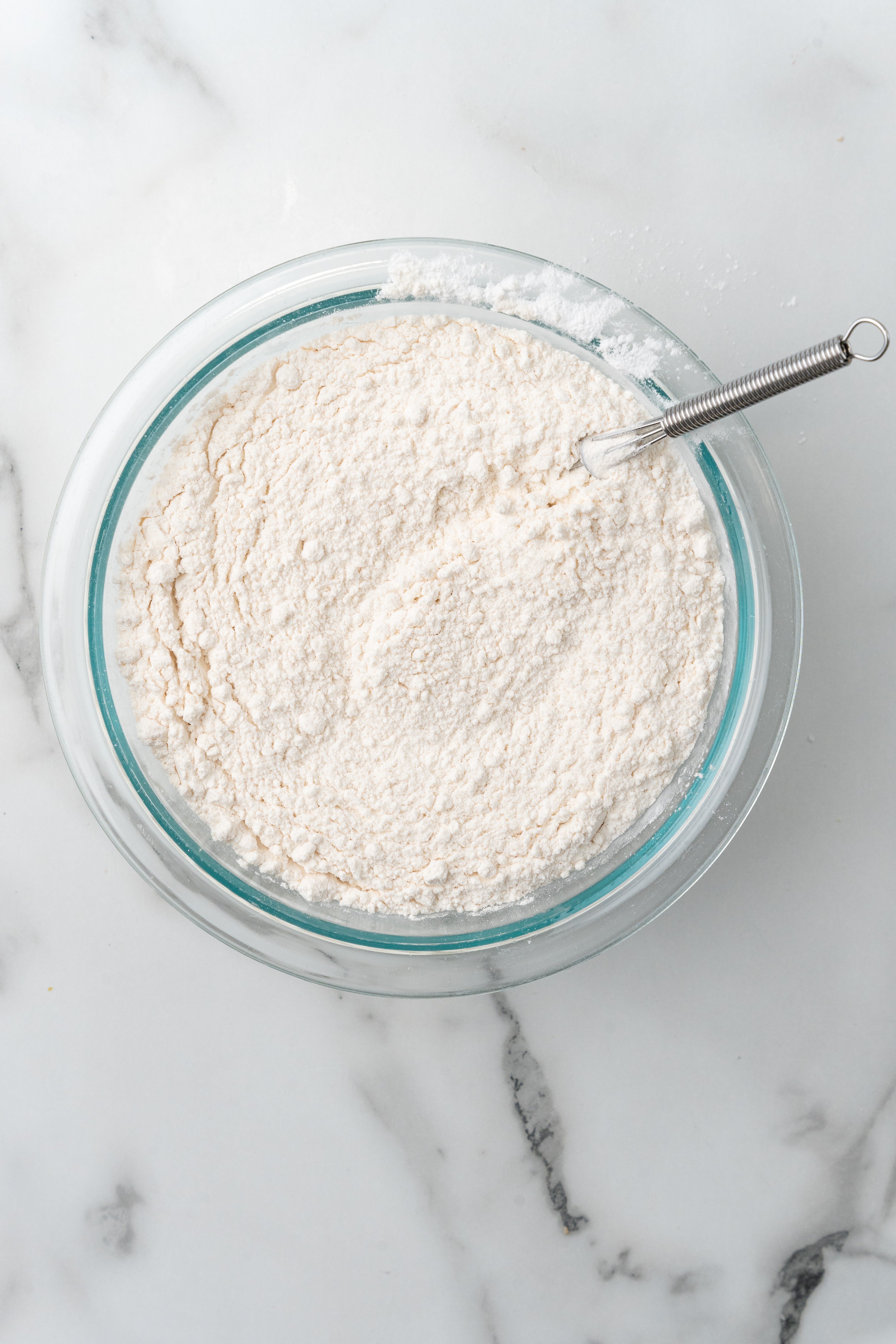 whisked flour in a glass mixing bowl