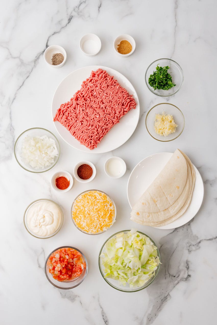 an overhead image showing the measured ingredients needed to make a batch of copycat quesadilla burgers