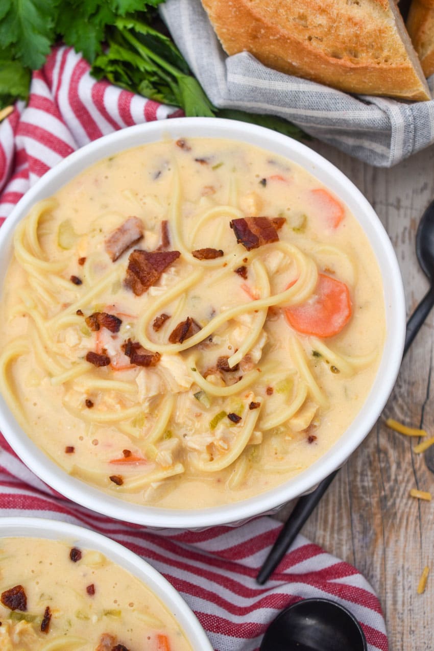 crack chicken soup in two white bowls