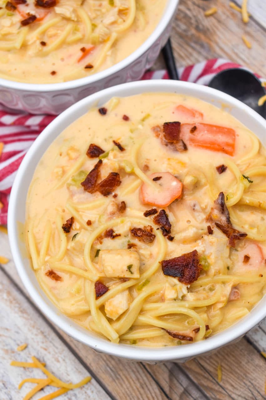 crack chicken soup in two white bowls