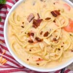 crack chicken soup in two white bowls