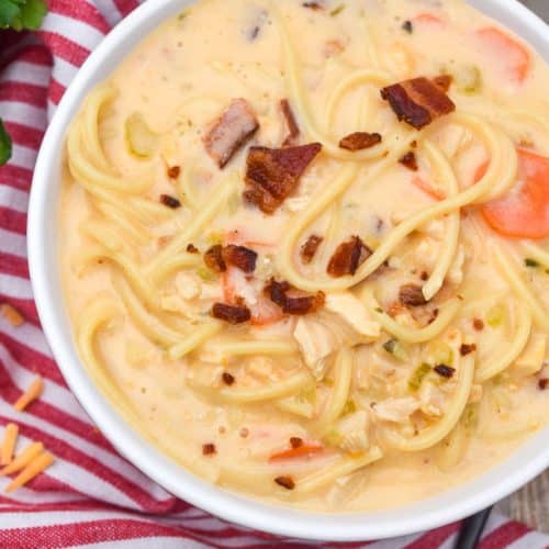 crack chicken soup in two white bowls