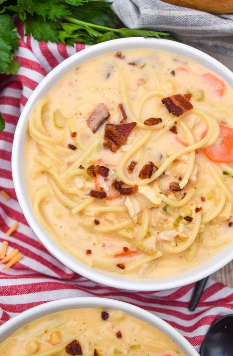 crack chicken soup in two white bowls