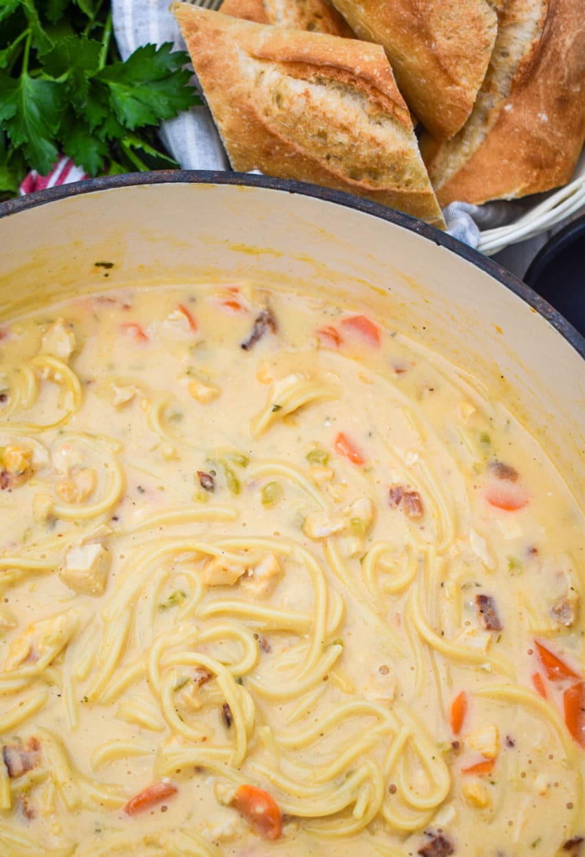 cheddar bacon ranch chicken noodle soup in a large dutch oven