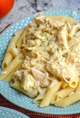 SLOW COOKER CREAMY ITALIAN CHICKEN AND PASTA ON A LIGHT BLUE PLATE