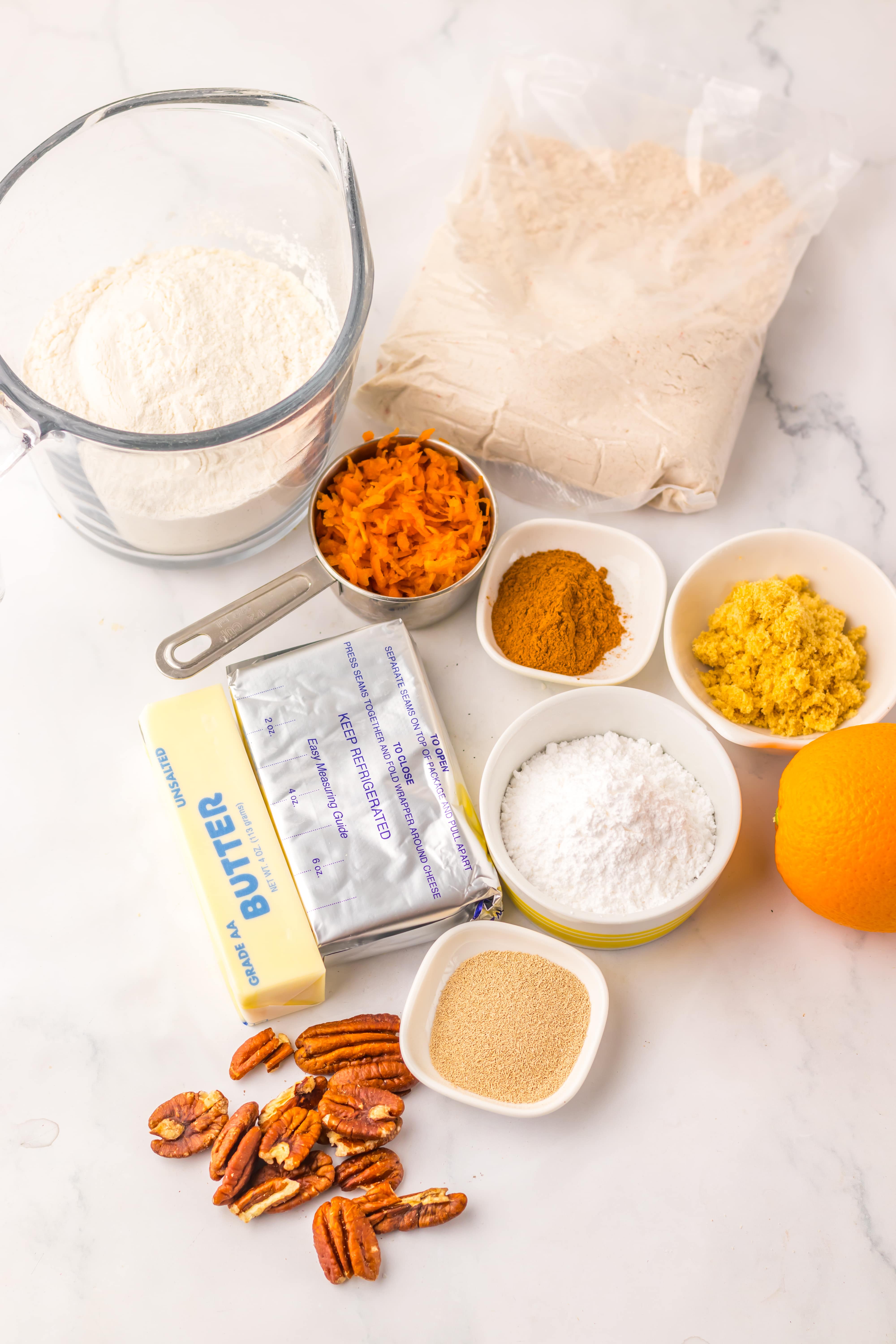an overhead image showing the measured ingredients needed to make a batch of homemade carrot cake cinnamon rolls