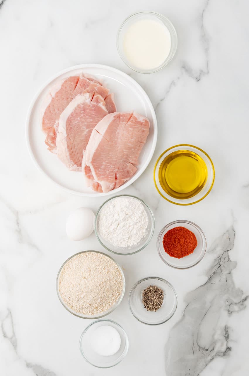 an overhead image showing the measured ingredients needed to make a batch of homemade pork schnitzel