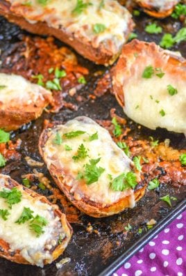 cheesy garlic roasted sweet potatoes topped with pieces of fresh parsley on a metal baking sheet