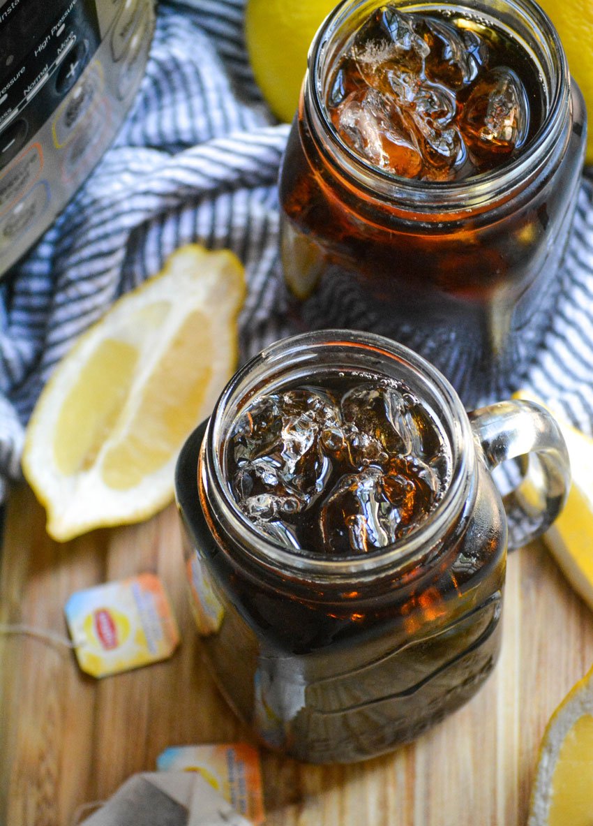 iced tea in glasses with ice with sliced lemons and an instant pot in the background