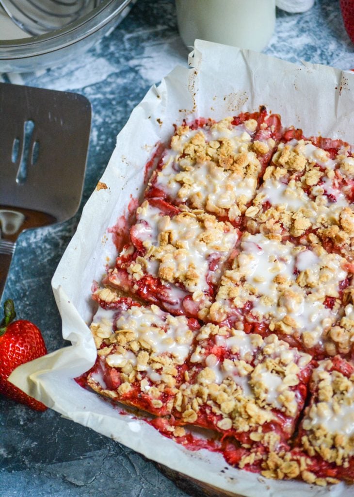 healthy strawberry oat bars on parchment paper and cut into squares