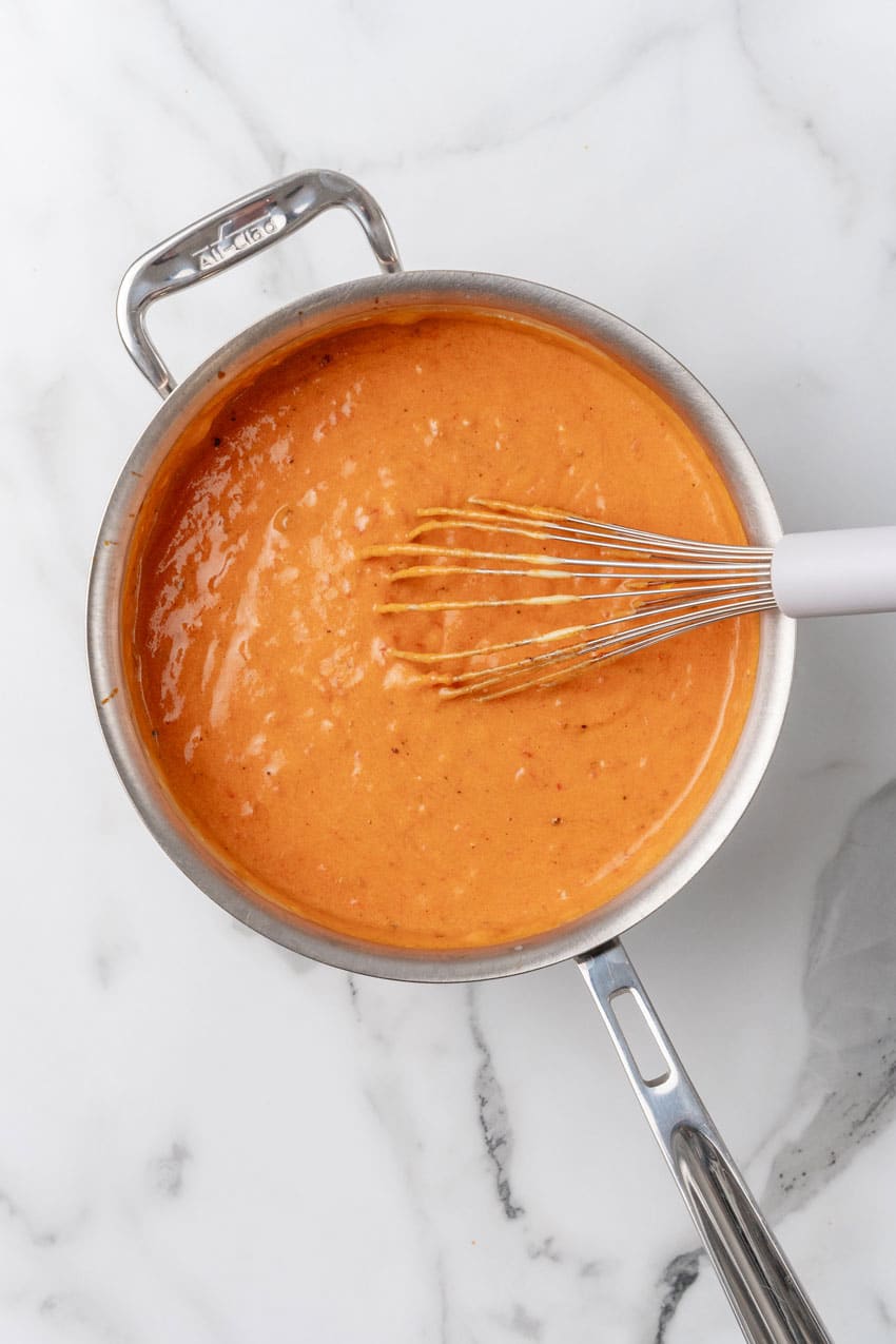 homemade cheese sauce in a large metal skillet
