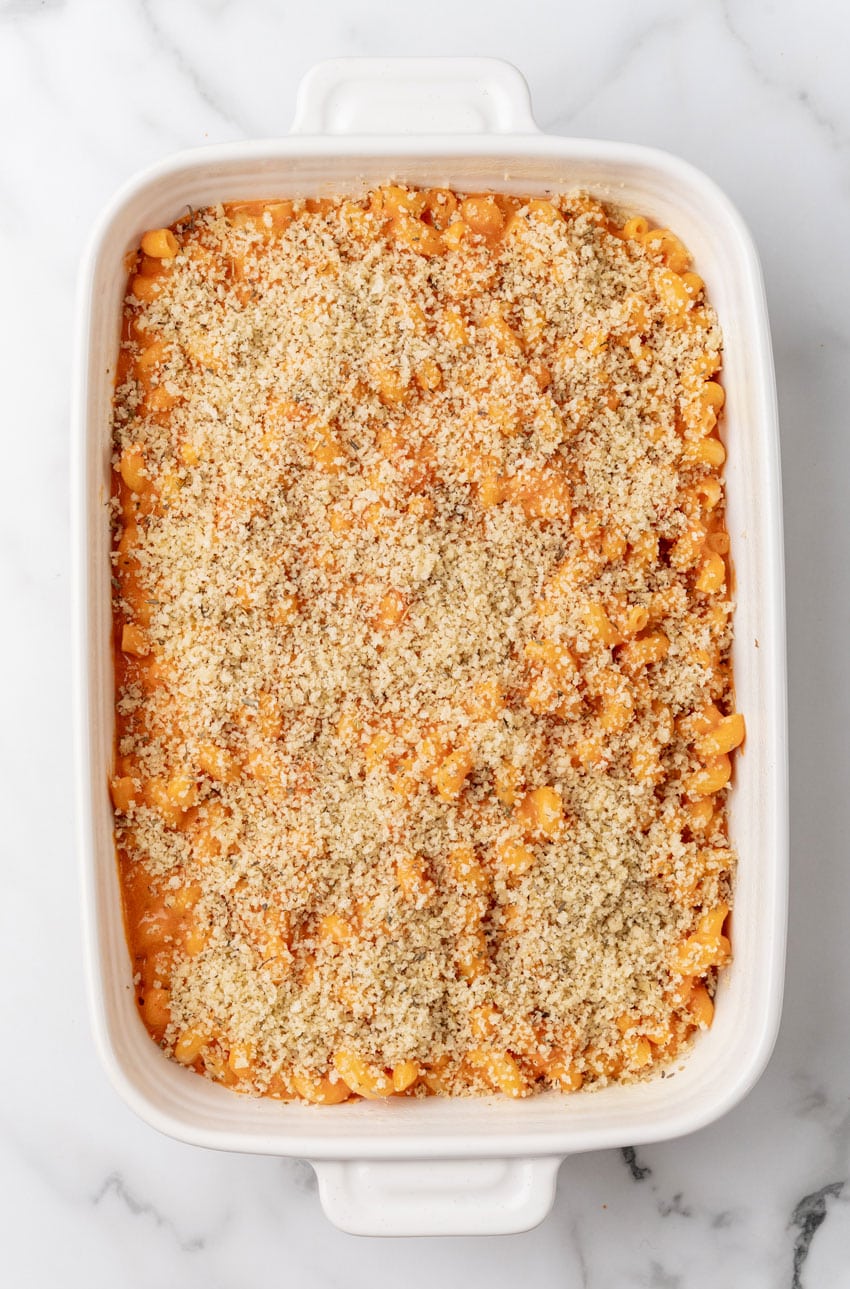 creamy tomato soup mac and cheese in a white baking dish