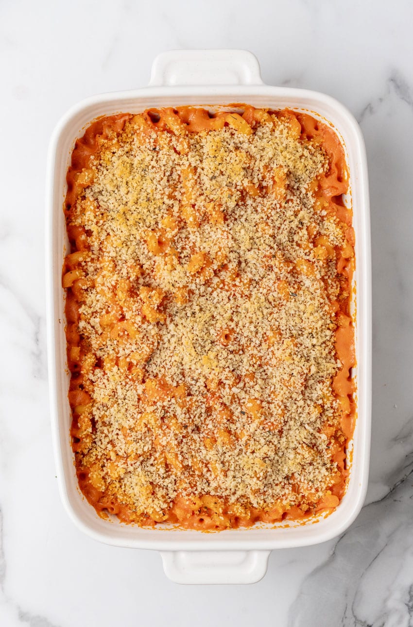baked tomato soup macaroni and cheese in a white casserole dish