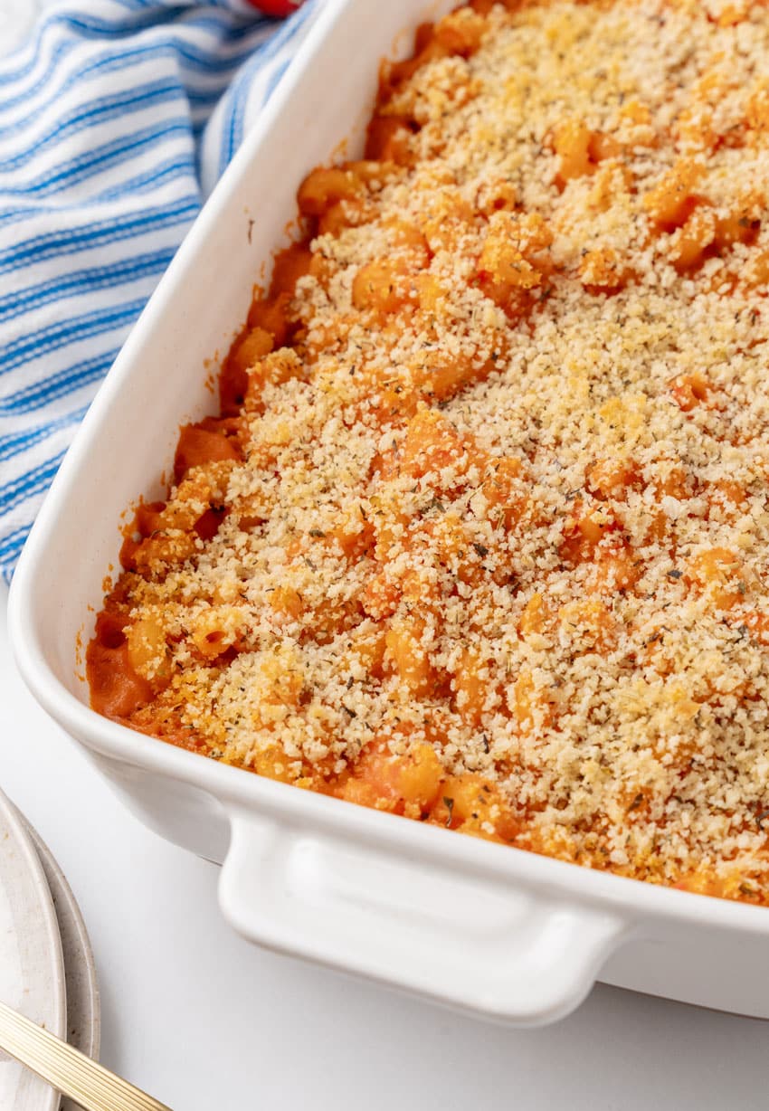 baked tomato soup macaroni and cheese in a white casserole dish