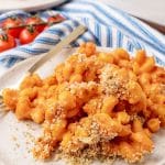 creamy tomato soup macaroni and cheese on a white plate