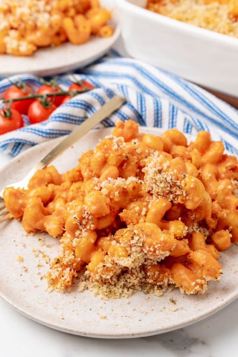 creamy tomato soup macaroni and cheese on a white plate