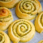 soft buttery pesto lined pinwheels shown on a silver baking tray