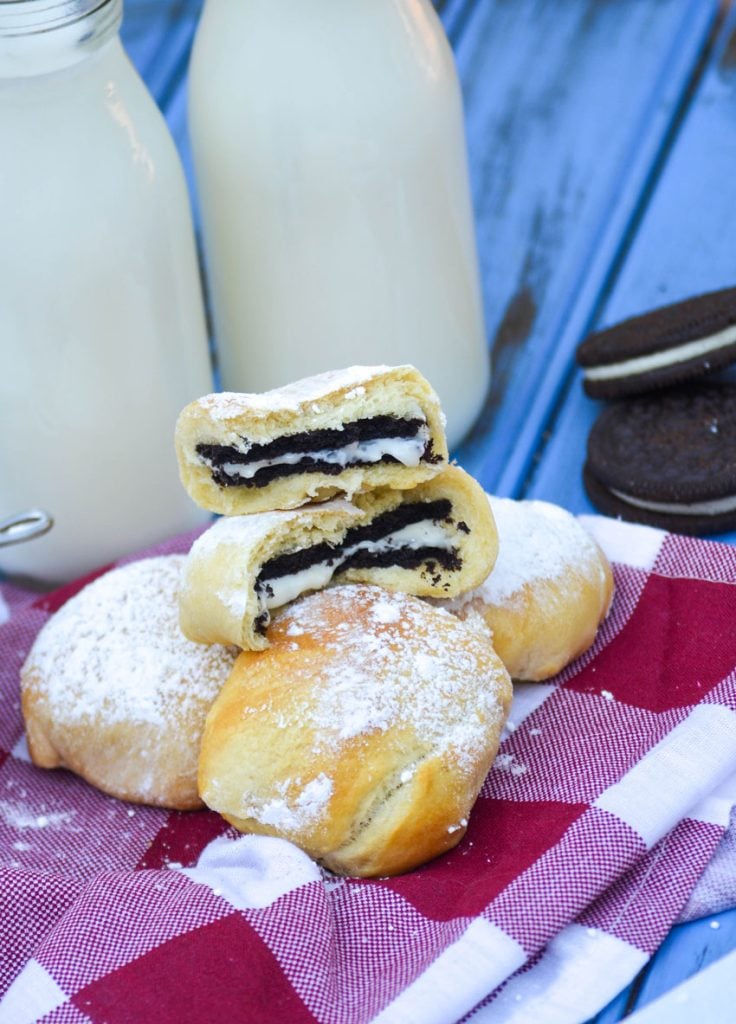 air fryer state fair style oreos on a checkered napkin with glasses of milk