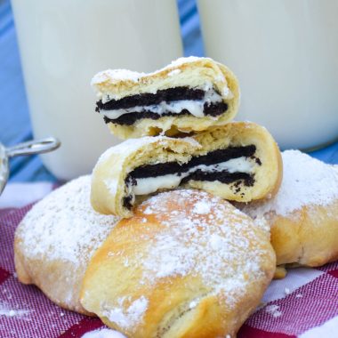 air fryer state fair style oreos on a checkered napkin with glasses of milk
