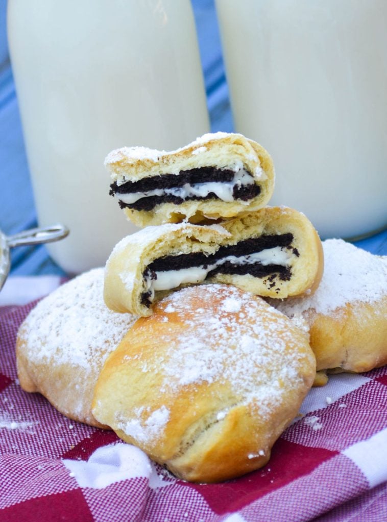 air fryer state fair style oreos on a checkered napkin with glasses of milk