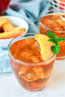 Peach Tea Recipe served in clear glasses and garnished with fresh peach slices and a sprig of mint