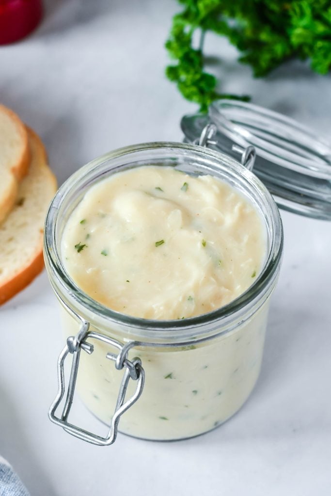condensed cream of chicken soup shown in an open glass storage jar