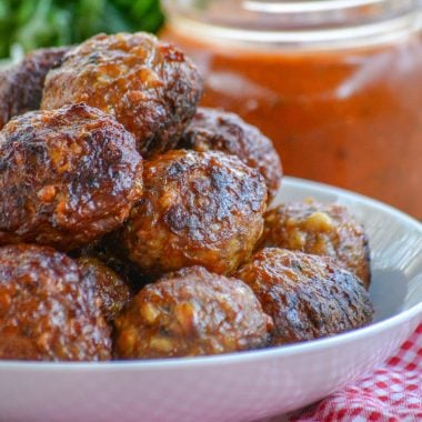 cooked homemade Italian meatballs stacked in a white bowl