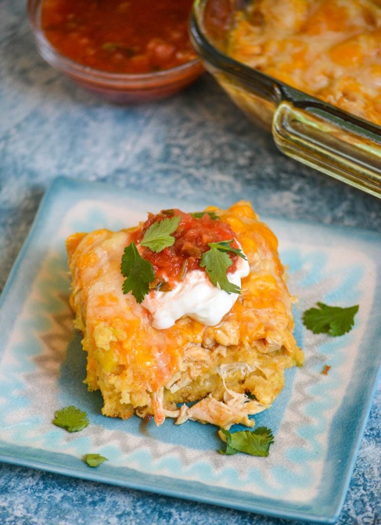 a slice of chicken tamale casserole shown on a blue square plate