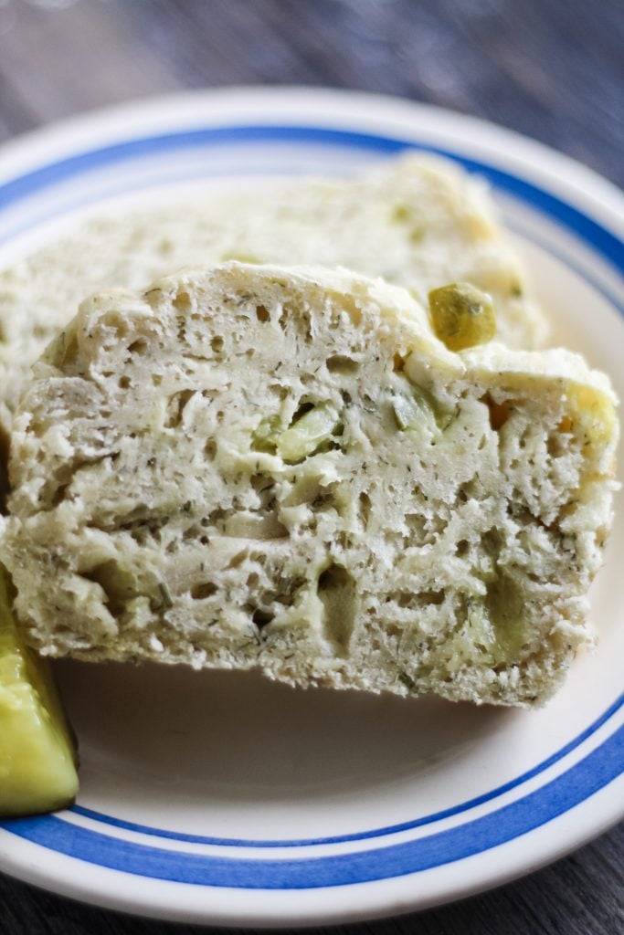 a slice of dill pickle bread on a blue rimmed white plate