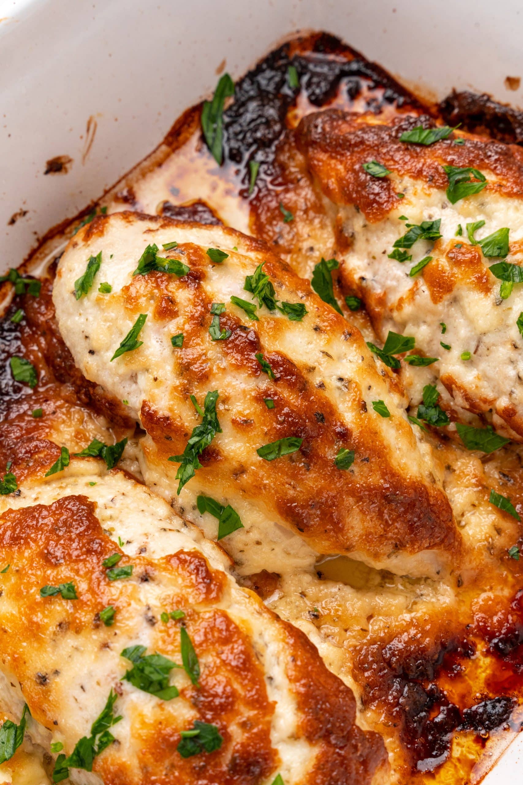 mayo parmesan chicken in a white baking dish