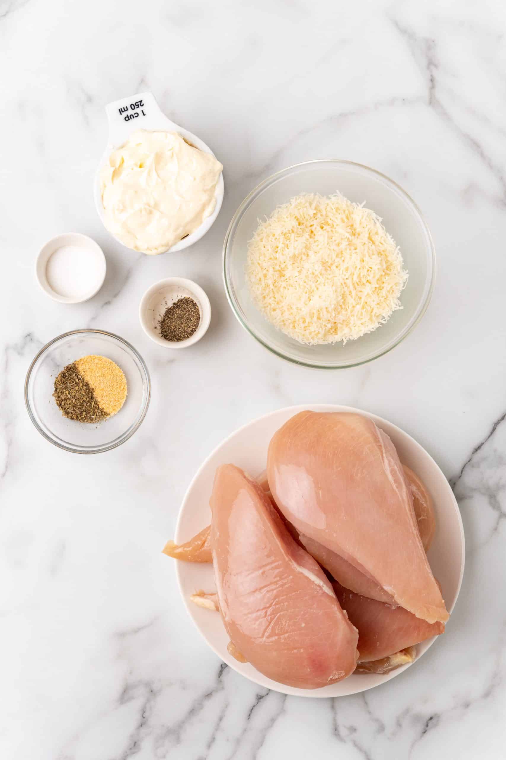 an overhead image showing the measured ingredients needed to make a batch of parmesan chicken with mayonnaise