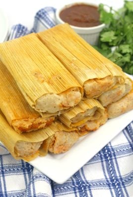 pork tamales stacked on a white serving plate