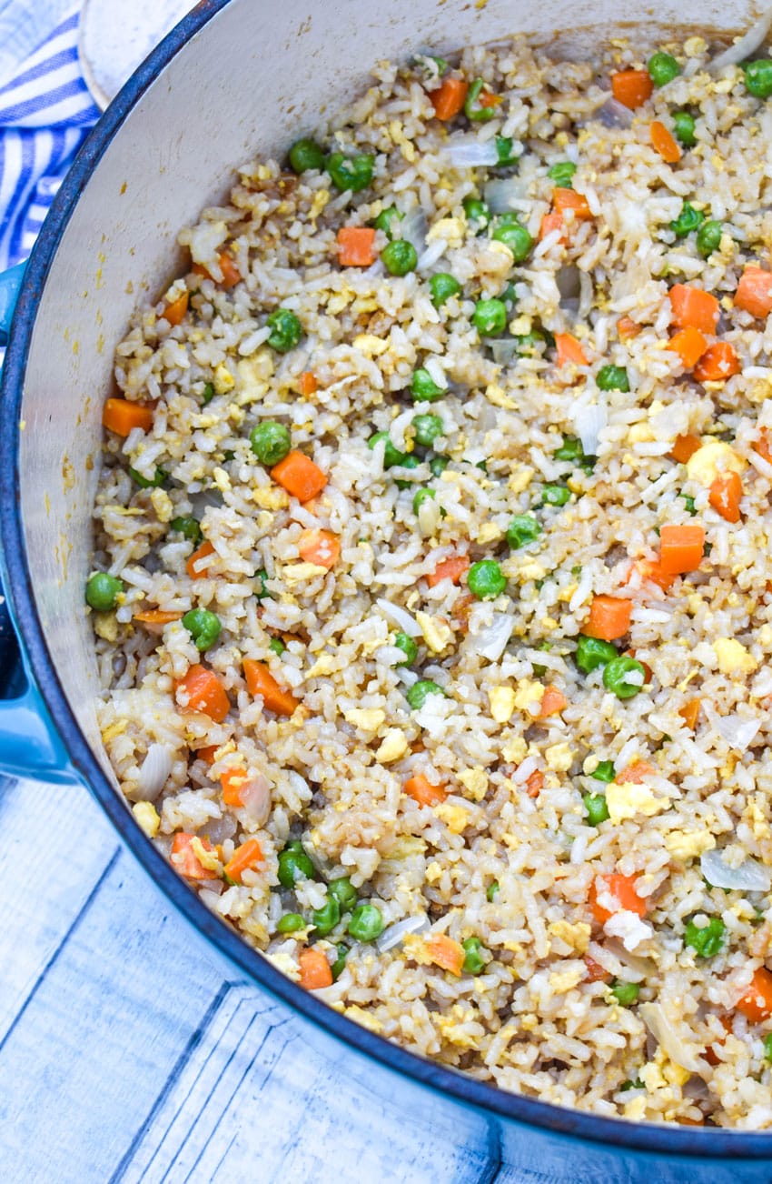 panda express fried rice recipe in a large dutch oven with fresh cilantro on the side