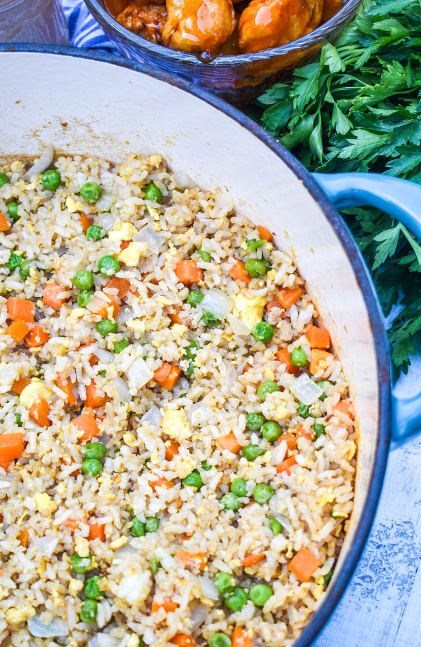 panda express fried rice recipe in a large dutch oven with fresh cilantro on the side