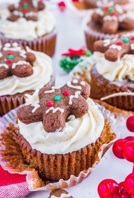 gingerbread cupcakes with spiced butter cream are shown topped with frosted gingerbread cookies