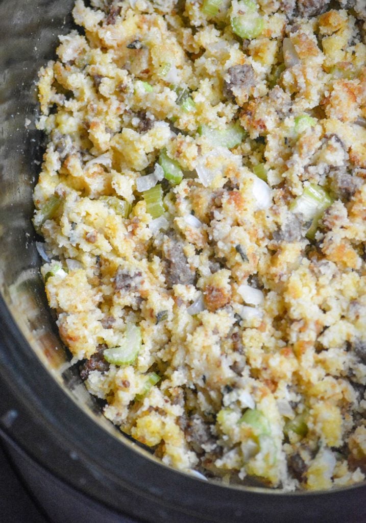 slow cooker cornbread & sausage stuffing shown in the black ceramic crock of a crockpot slow cooker
